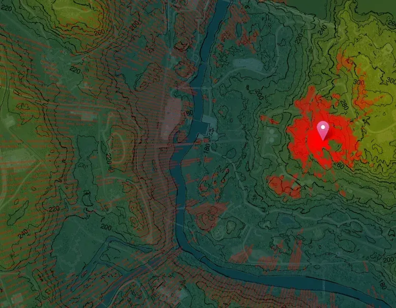 Squad LOS map with a pin on a hill; the areas that can see the pin are shaded red, the rest of the valley stays clear